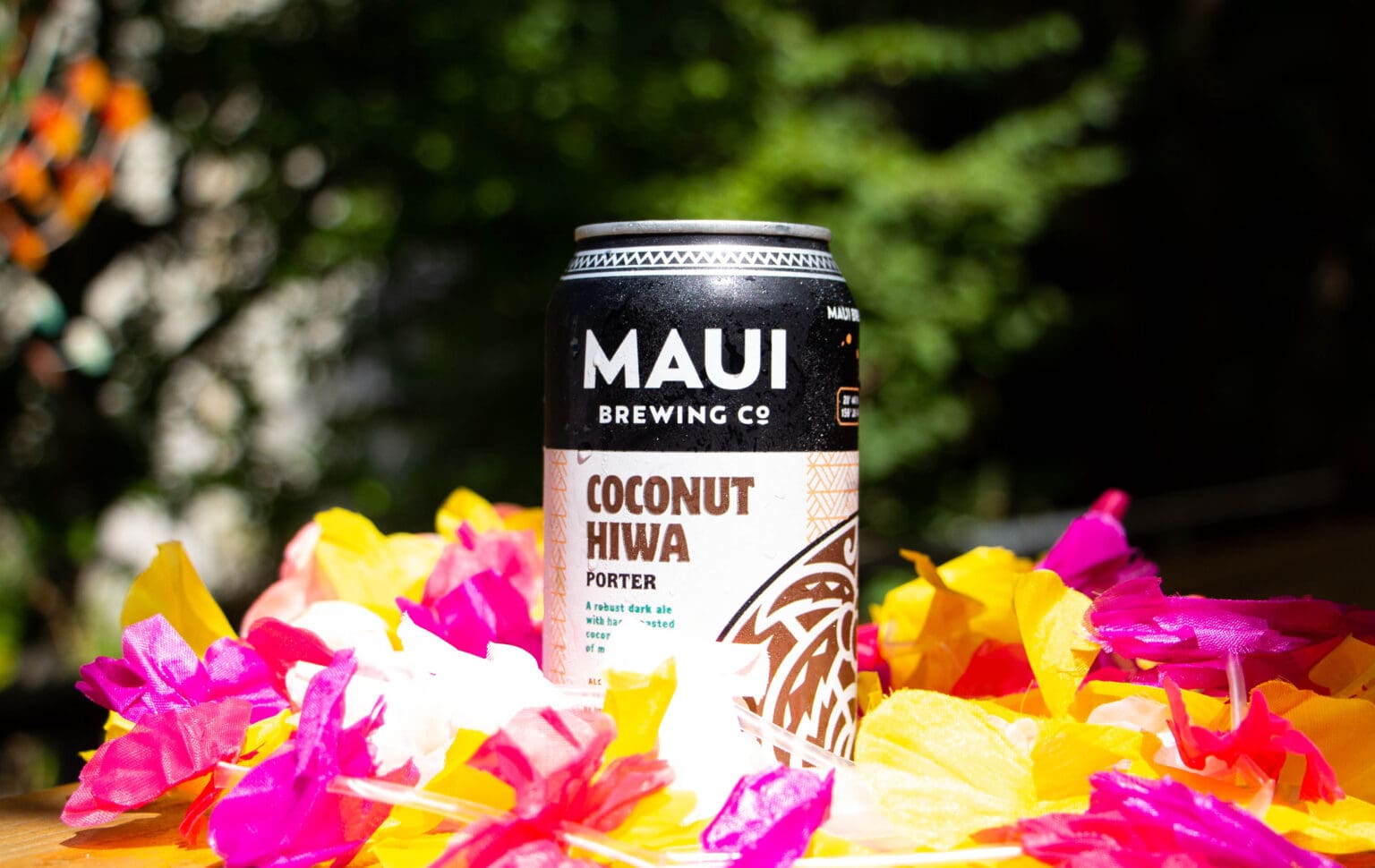 Boundary Bay Brewery's selection includes leis and Coconut Hiwa Porter from Maui Brewing Co. placed on top of multi-colored flowers.