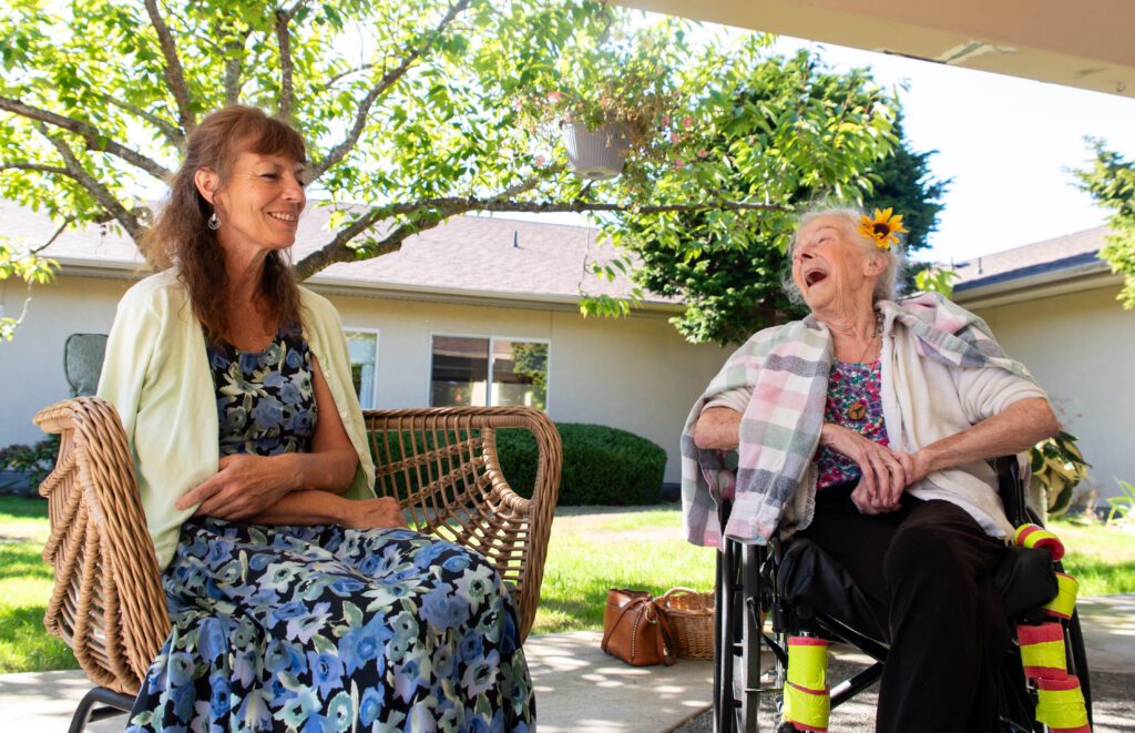 Darlene Little, right, laughs as daughter Laurie Lee Lewis recounts a story.