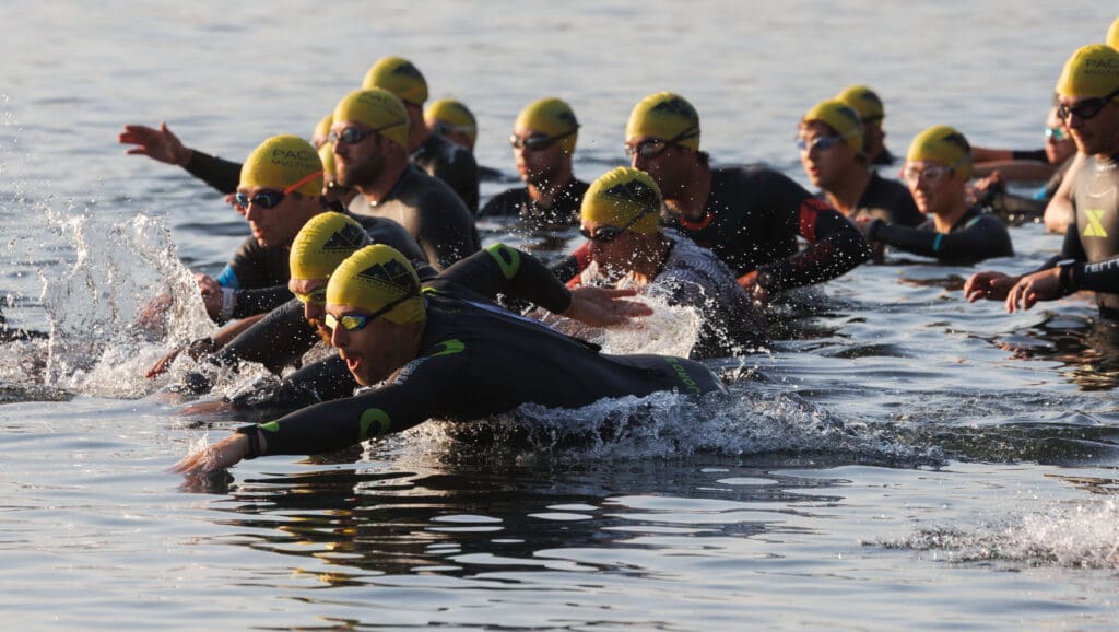 Racers dive into Lake Whatcom with water splashing around them from the start.