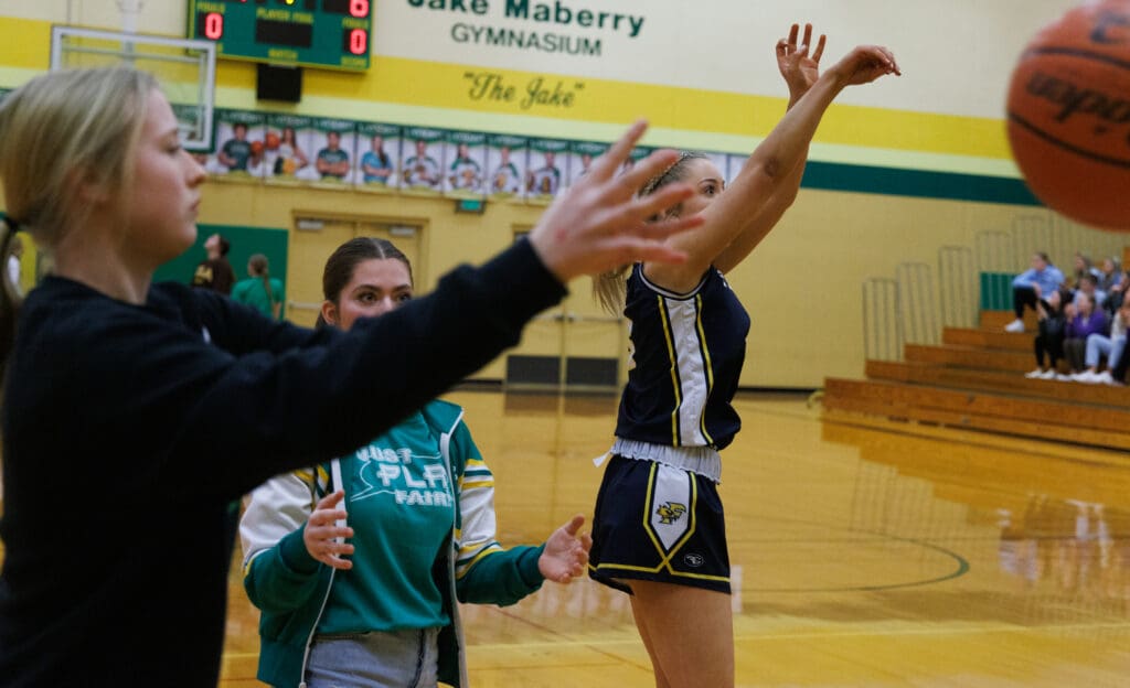 As volunteers pass balls to her