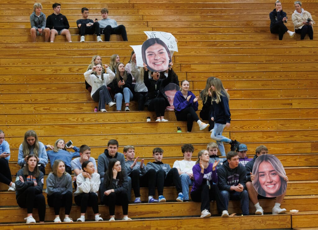 Meridian fans hold up a photo of Avery Neal