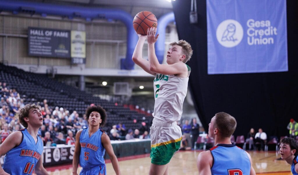 Lynden’s Brady Elsner leaps to make a shot as other players surround him and watch from below.