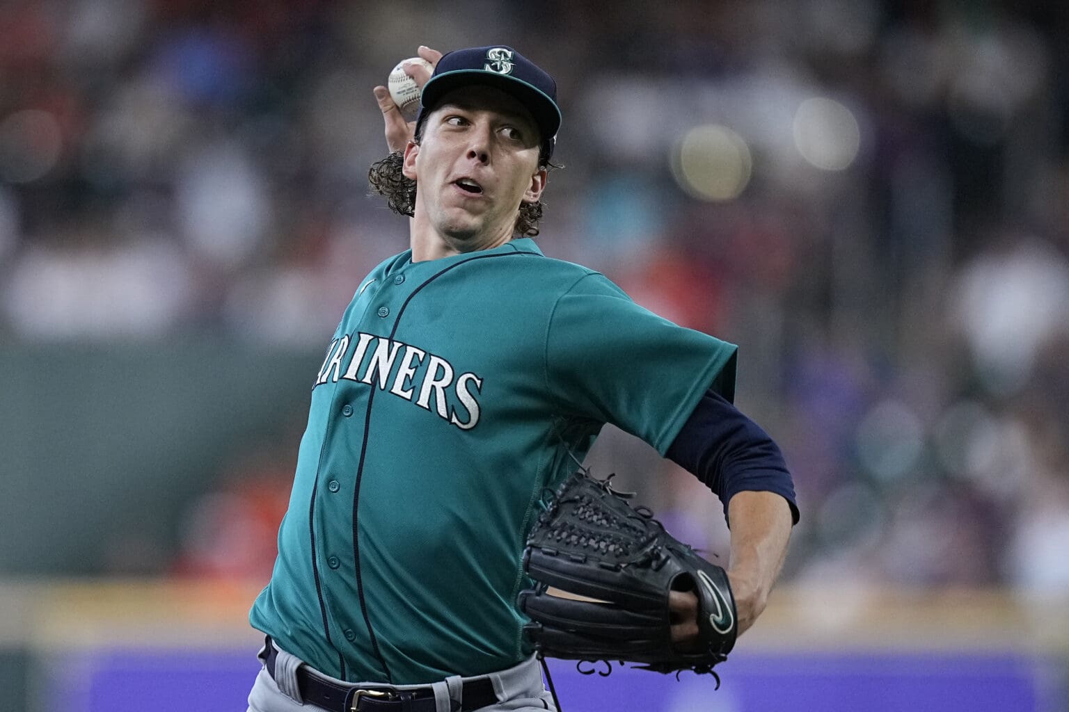 Seattle Mariners starting pitcher Logan Gilbert pulls back his arm to throw the ball.