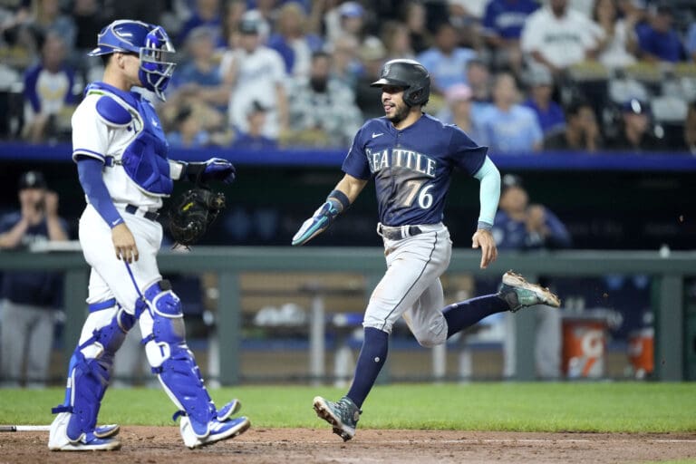 Seattle Mariners' Jose Caballero (76) runs home as the crowd watches from the bleachers.