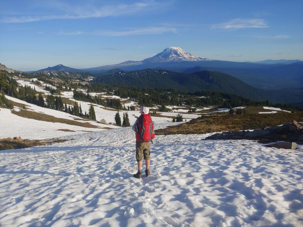 Caden Martin takes in the view of Mount Adams on the snowy wilderness along the Pacific Crest Trail.