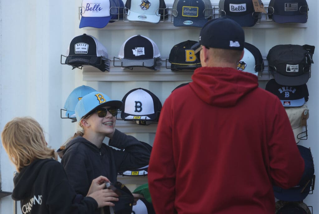 Kaelyn Hinton shows off a hat to her dad