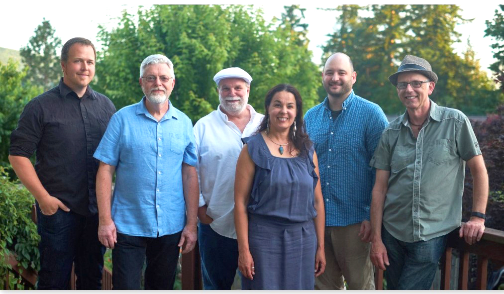 Bilongo, a seven-piece Latin jazz group, poses for a photo with a wide smile.