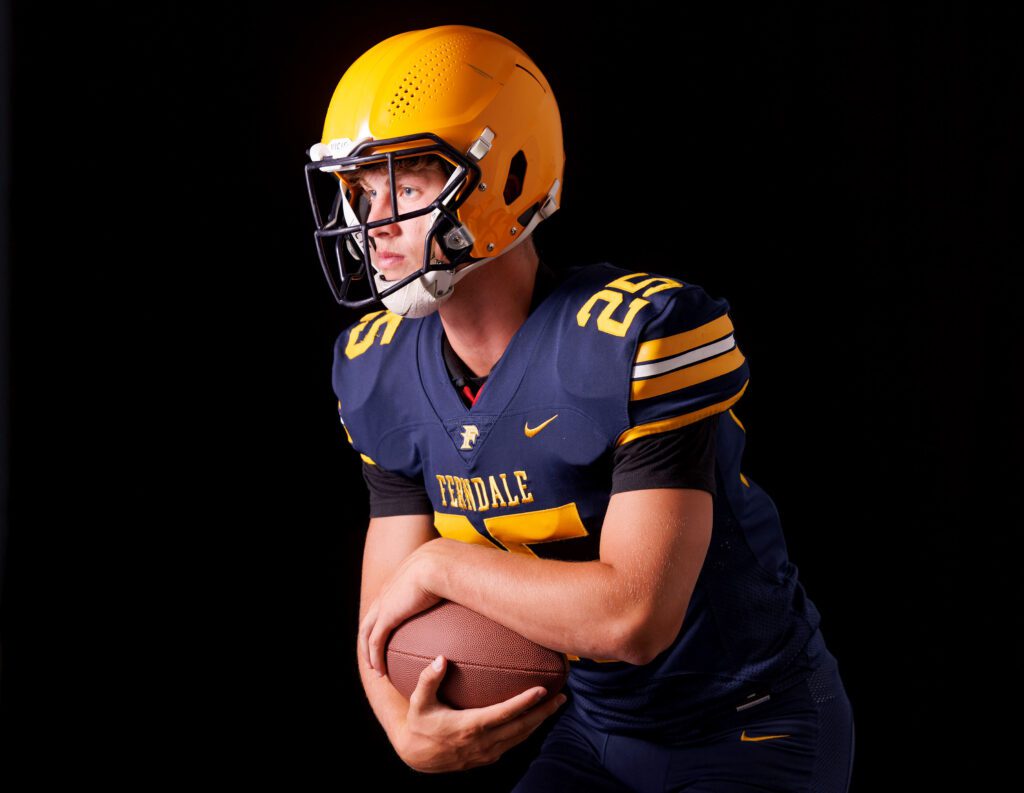 Ferndale football wing back and strong safety Conner Walcker holds the football close to him.