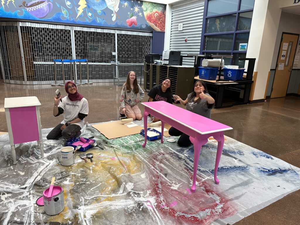 Rayyan Salam, left, Kate Cohoe, Izzy Santana and Heidi Torres-Beltran paint set pieces pink for "Legally Blonde: The Musical."