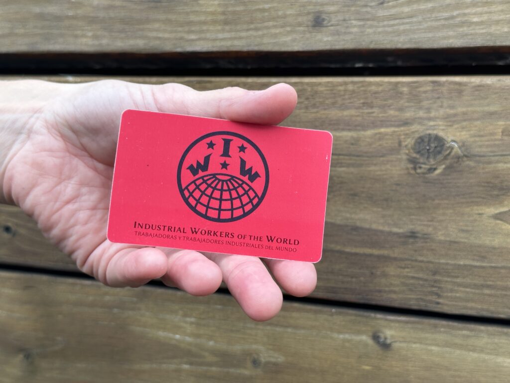 Wobblies' red membership card has a logo of their initials over the world.