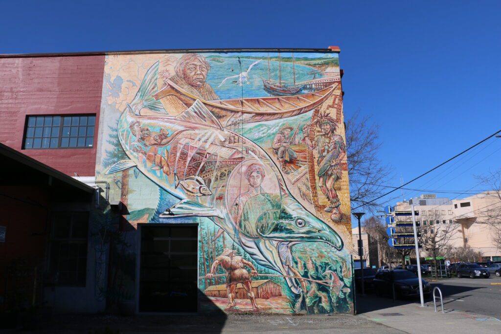 A colorful salmon mural with environmental stories of Whatcom Creek.