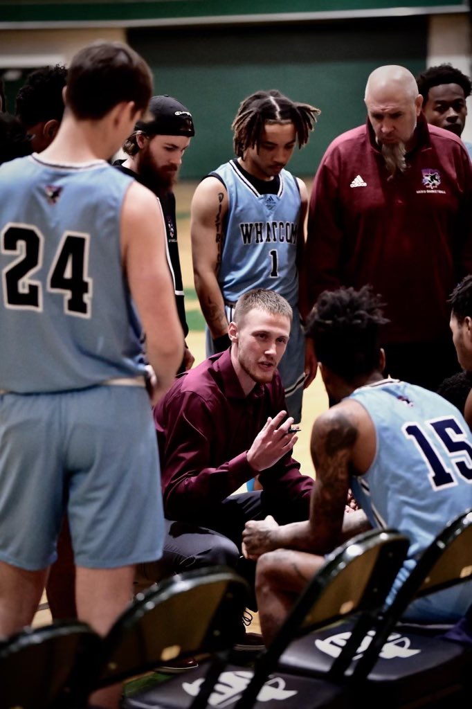 Alex Sommerfield coaches his players in a close huddle