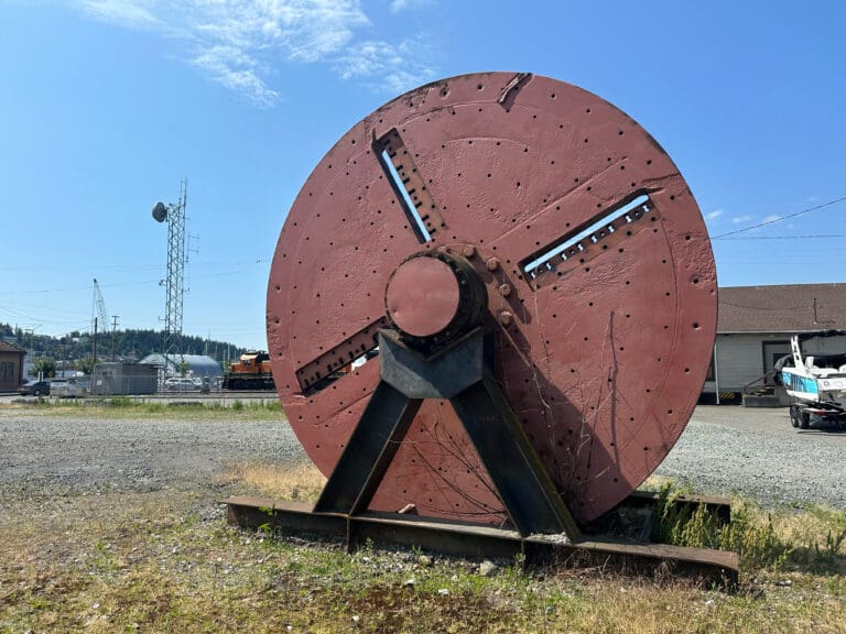 An old Georgia-Pacific log chipper sits on the corner of Holly and E streets.