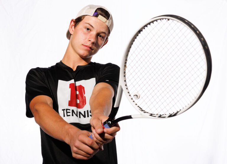 Bellingham boys tennis singles player Jacob Kuhn holds up a bracket to the camera.