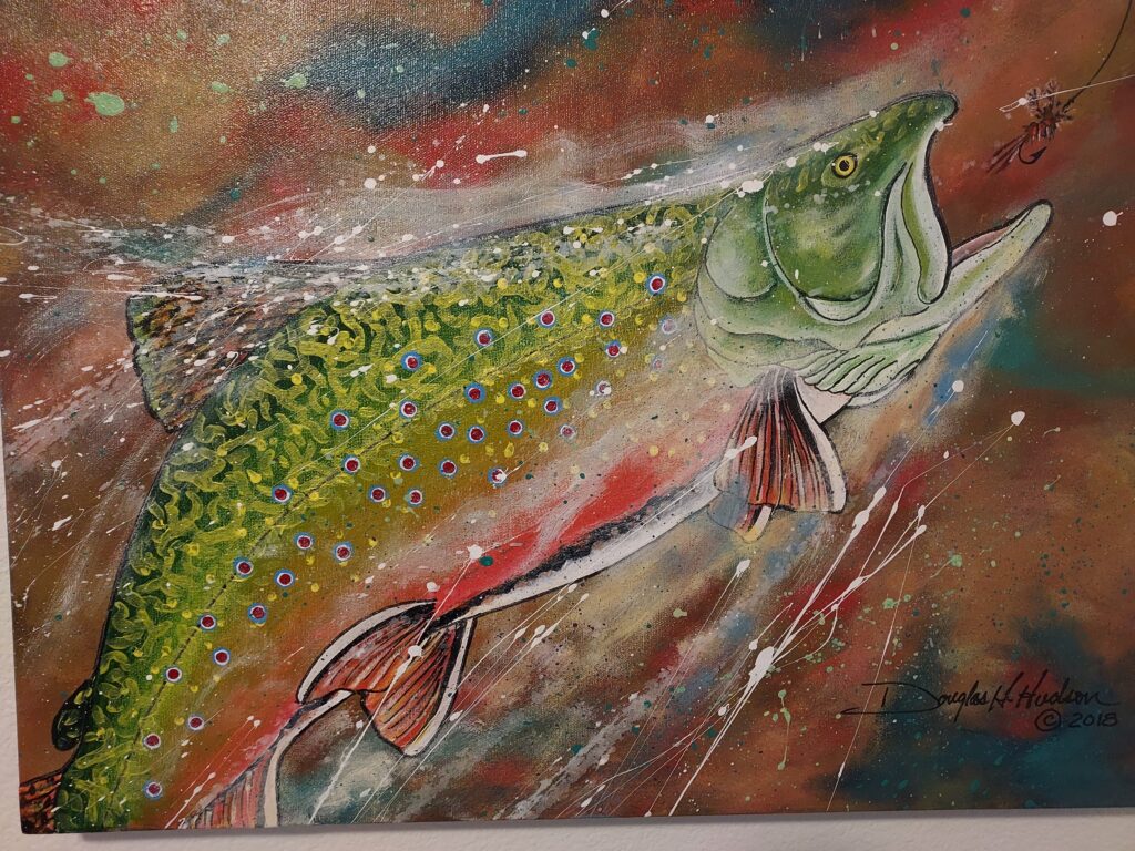 A painting of a salmon with detailed designs of their scales.