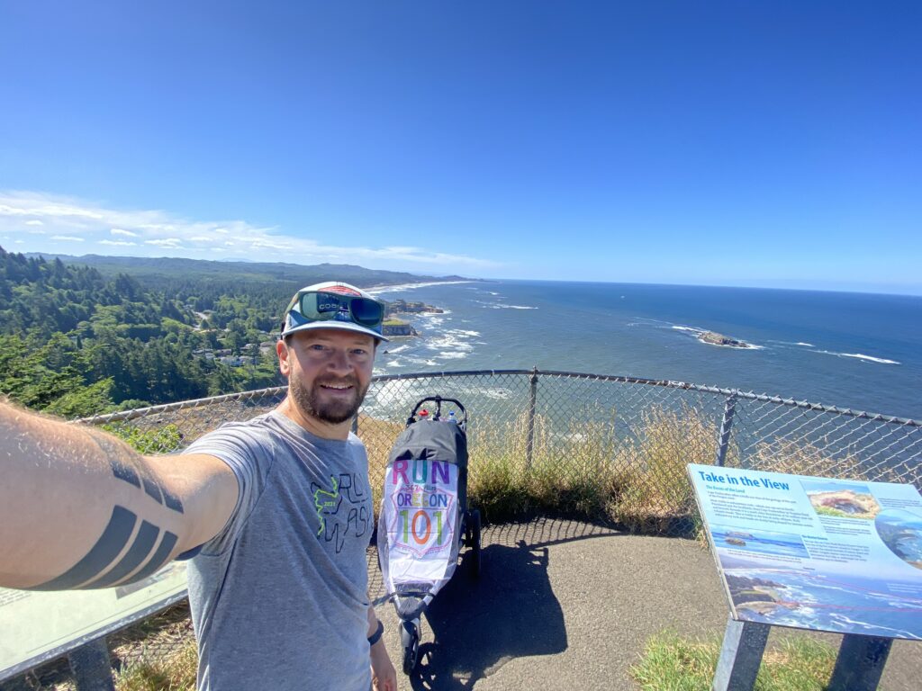 Marcus Nuckolls takes a selfie on the Oregon coast with a baby stroller.