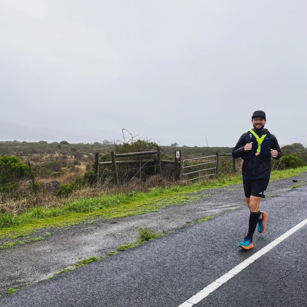 Marcus Nuckolls runs along a street in Olema with a smile.