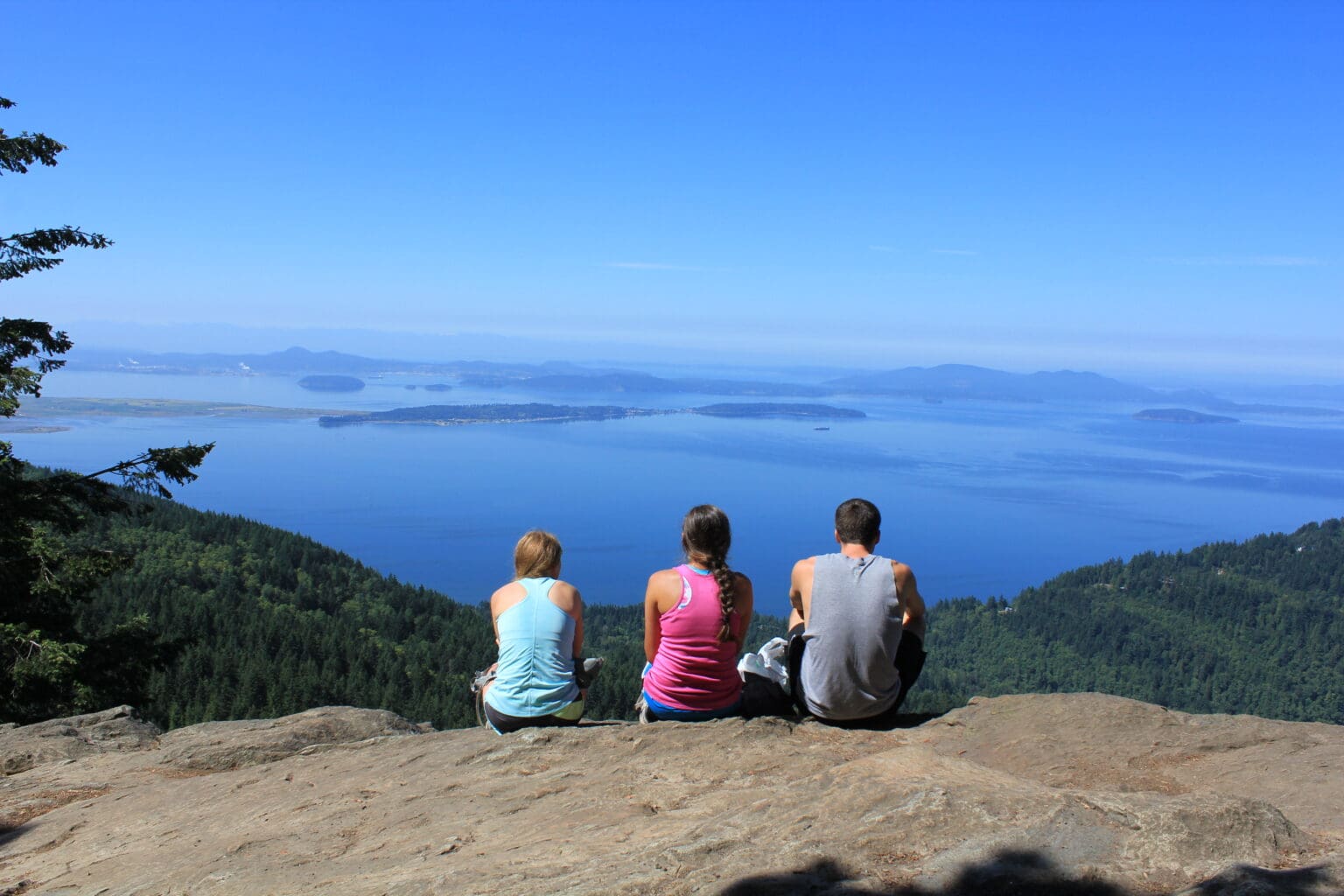 A Trek for Treasure team stops for a break on the edge of the mountain during the Oyster Dome hike.