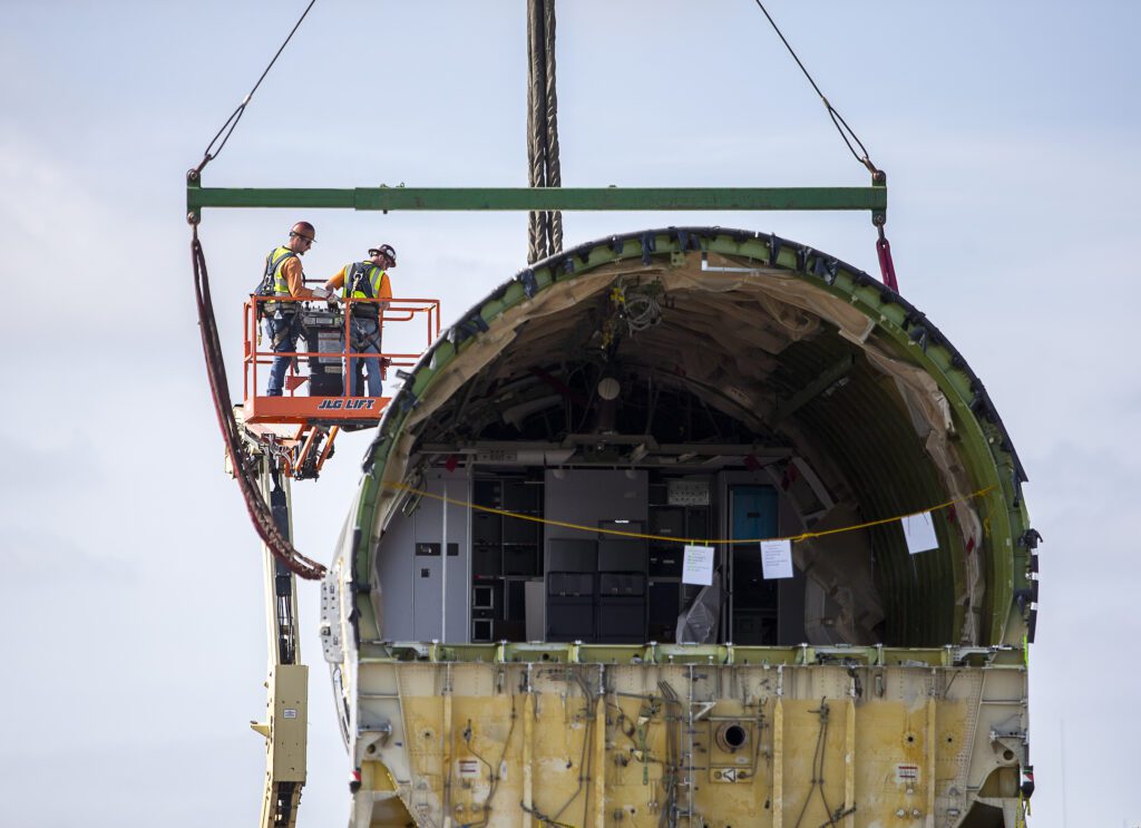 Omega Morgan employees secure steps to the fuselage.