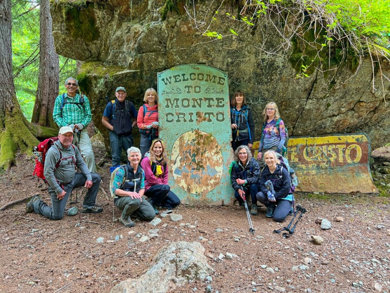 A group of Bellingham hikers pose in front of the Monte Cristo sign.