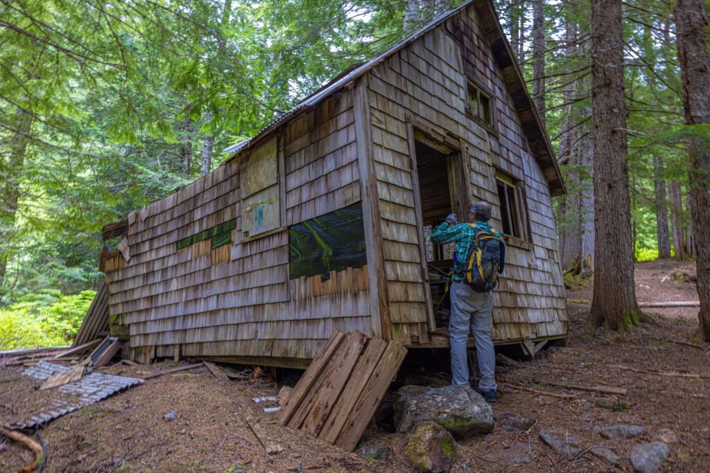 Michael Botwin of Bellingham peers into a rundown wooden dwelling.