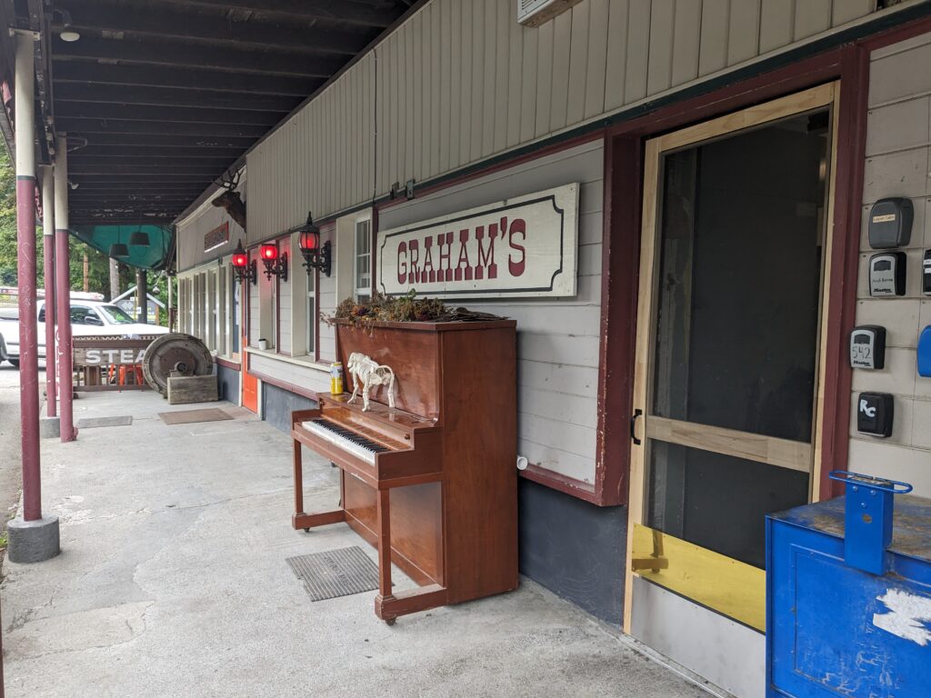 From the outside, Graham's sign hangs over a wooden piano.