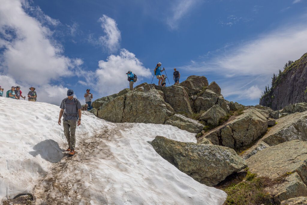 Bellingham EMT Alex Honn navigates the snow as other hikers take turns taking photos.