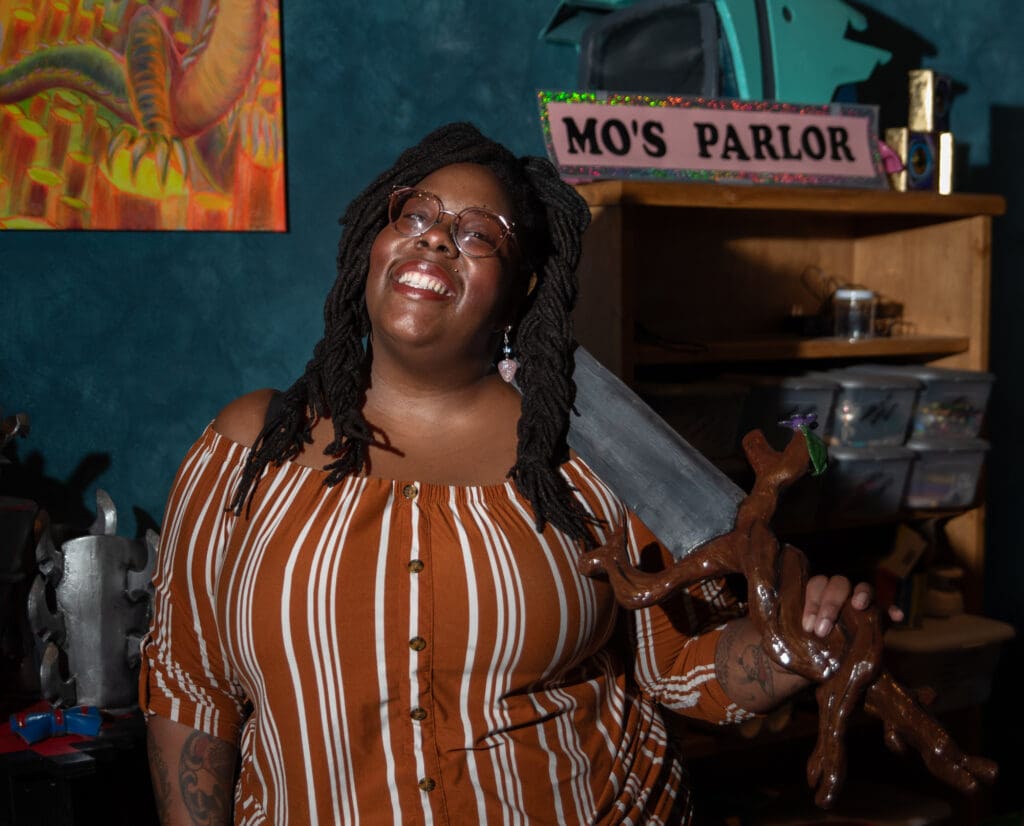 Monique Green holds a hand-crafted sword in her downtown Bellingham studio on Jan. 18. Mo is the owner of Mo's Parlor