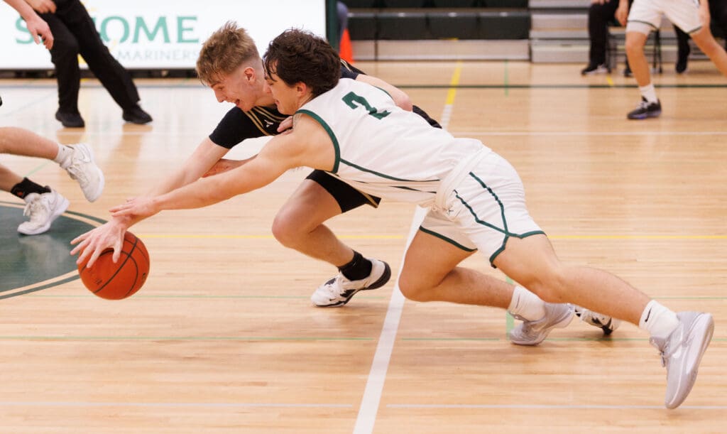 Sehome’s Nolan Wright and Meridian’s Jaeger Fyfe dive for a loose ball.