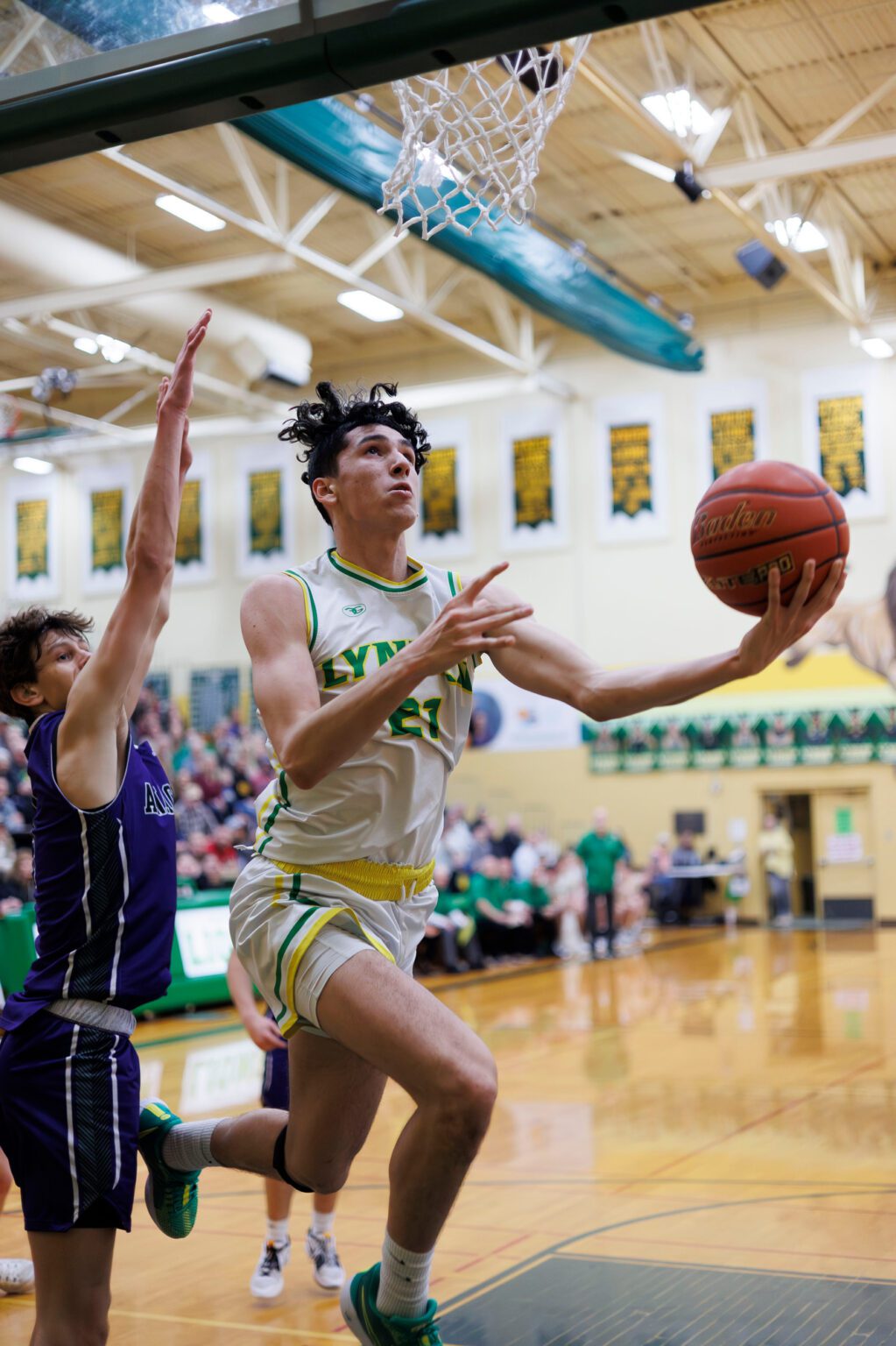 Lynden’s Anthony Cananles drives past Anacortes’ Davis Fogle for the basket as he tries for a lay-up.