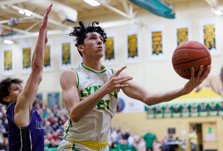 Lynden’s Anthony Cananles drives past Anacortes’ Davis Fogle for the basket as he tries to layup.