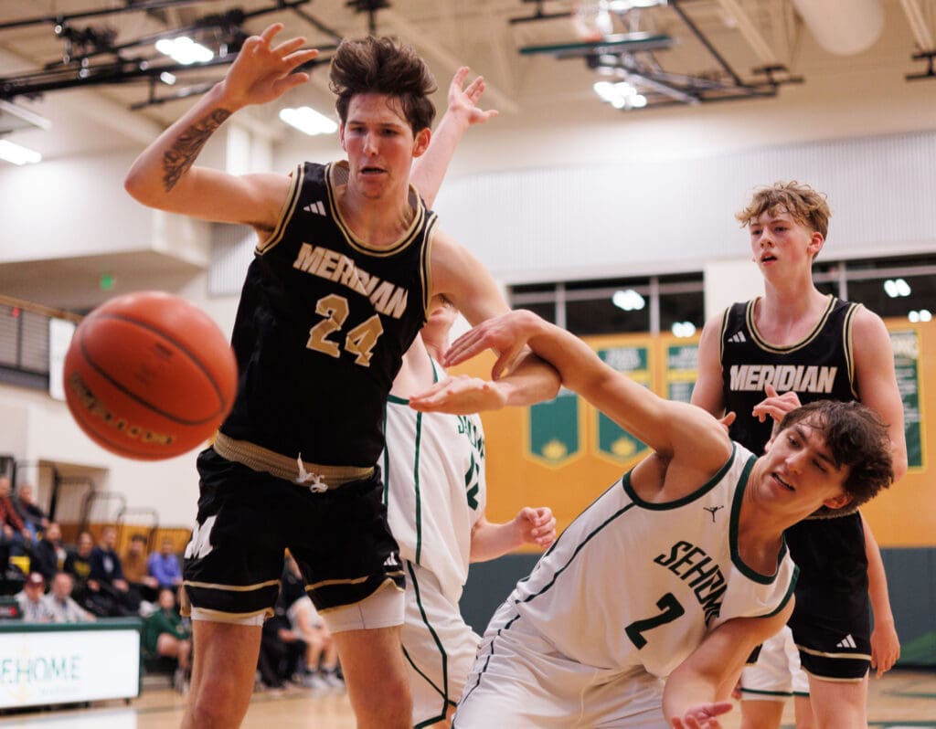 Meridian’s Christian Clawson tries to maintain control of the ball as other players attempt to take control.