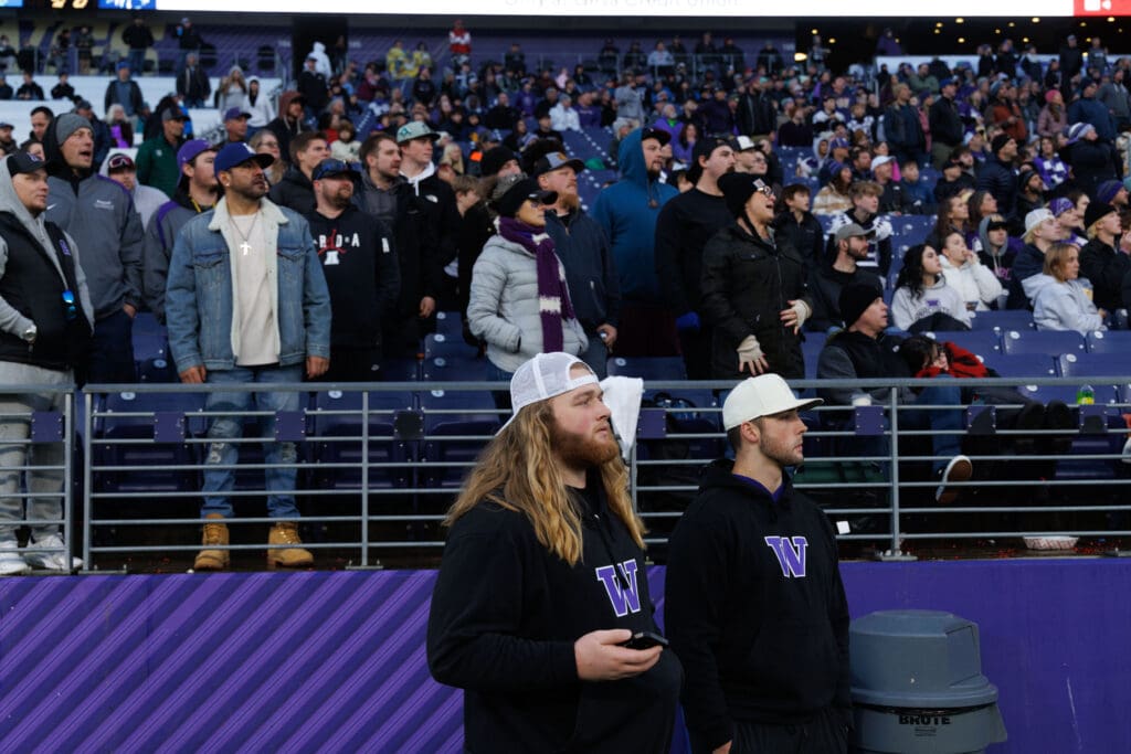 University Washington football players and Ferndale alums Landen Hatchett and Jake Mason watch as Anacortes beats Tumwater.