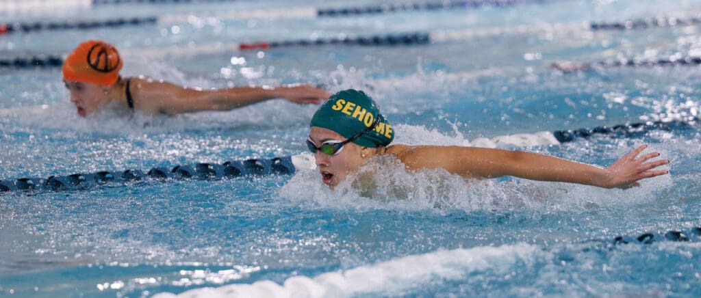 Jordis Darroch pulls ahead of Blaine's Hailey Ferrell as they both propel themselves up and forwards with their arms.