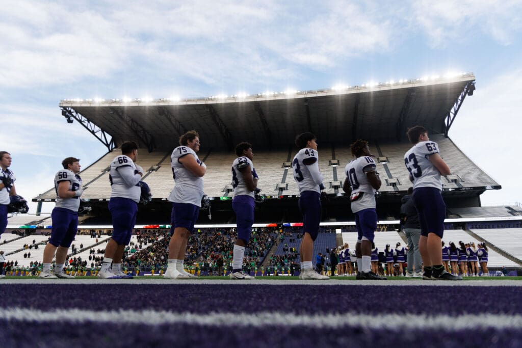 Anacortes players line up for the national anthem before taking on Tumwater in the 2A state championship game.