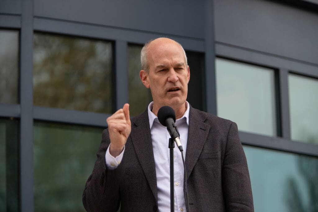 U.S. Rep. Rick Larsen speaks through a mic.