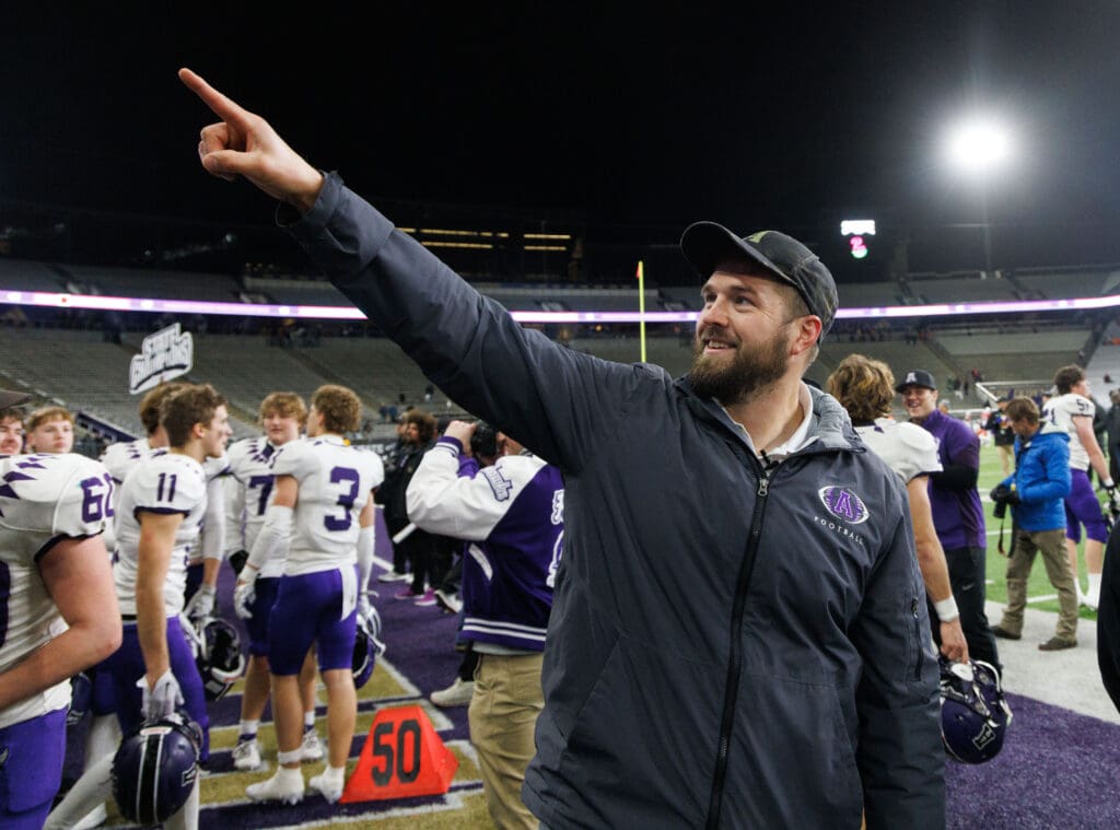 Anacortes head coach Travis Anderson points to students and fans after beating Tumwater.