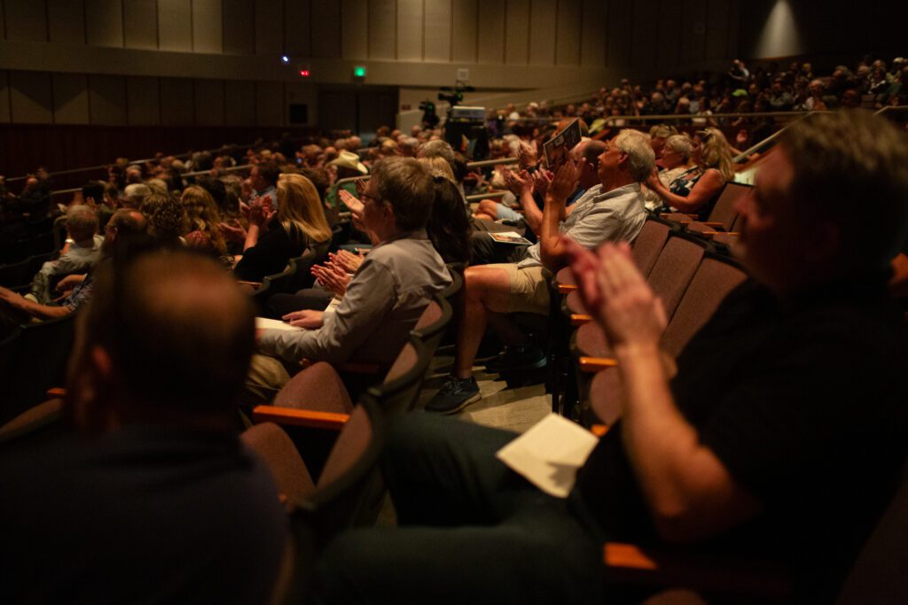 Attendees clap to honor Mark Scholten.