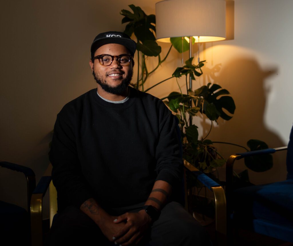 Remy Styrk sits in the healing room at Northwest Youth Services with a smile.