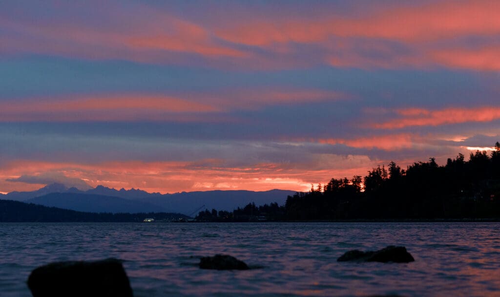 The sky is a mix of orange and blue colors as the sun sets.