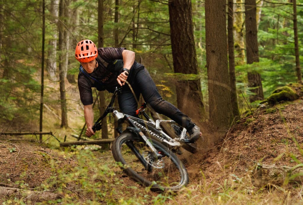 Talus Lantz turns sharply inbetween the trees and dirt.