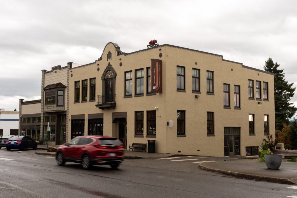 A car drives by the Jansen Art Center building.