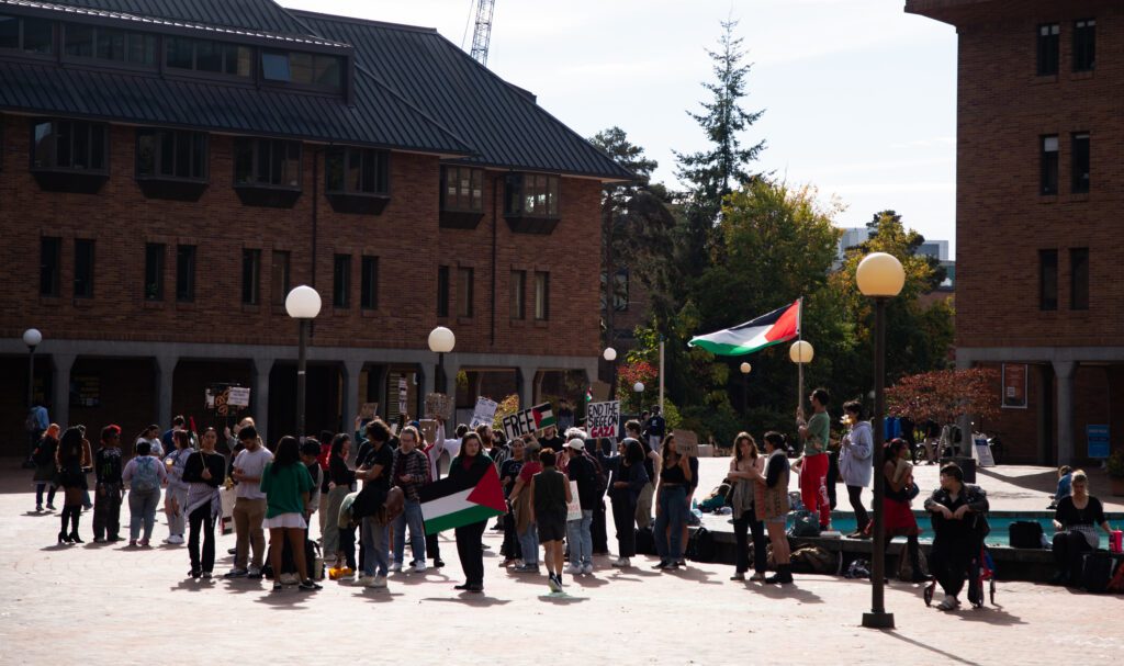 A crowd of Western Washington University students group up with their signs and flags in support of Palestine.