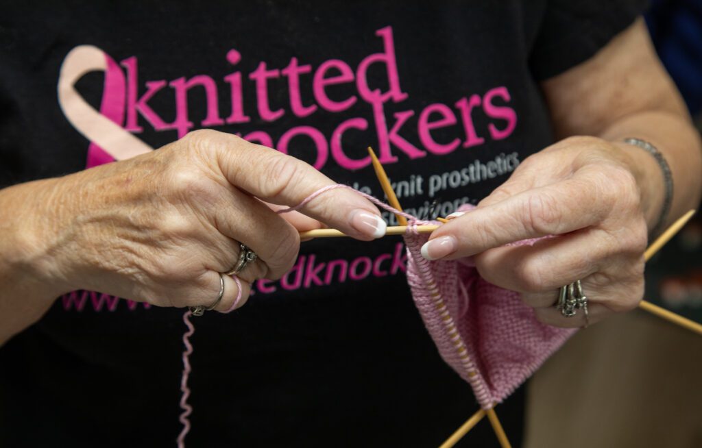 Char Malseed knits a knocker with pink yarn.