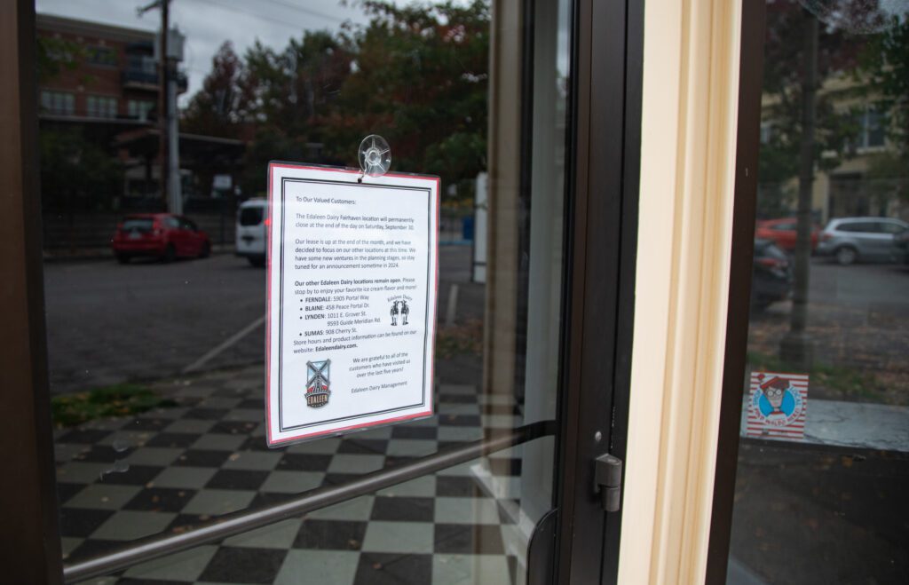 The door of Edaleen Dairy has a paper addressing their customers of the closing of their Bellingham location.