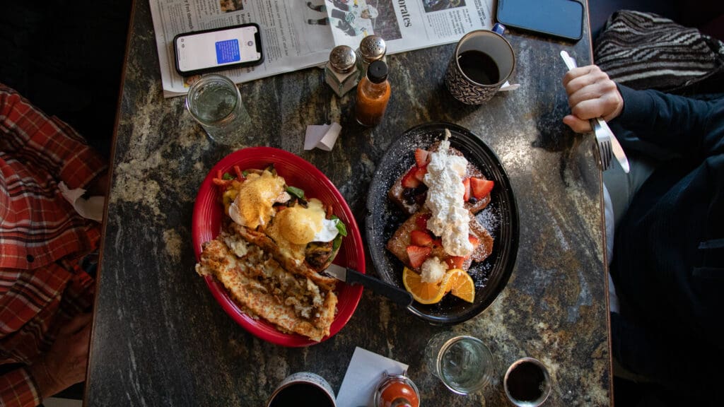 Diners prepare to feast on a veggie eggs benedict and french toast.