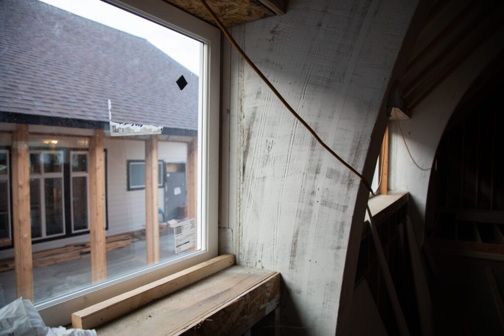 The interior of the church has old wooden structures next to the windows.