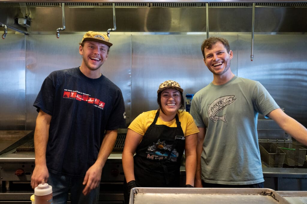 From left, Tim Comfort, Stephanie Vigil and Timothy William pose for a photo inside Raven Hut on opening day.