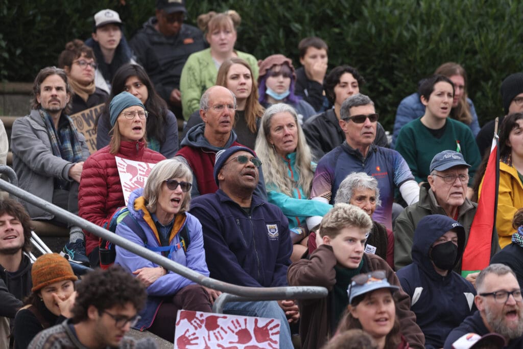 Supporters sing a song from the steps in support of the rally.