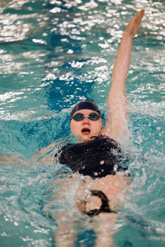 Kate Truemper swims backwards as she opens her mouth to take a breath in.